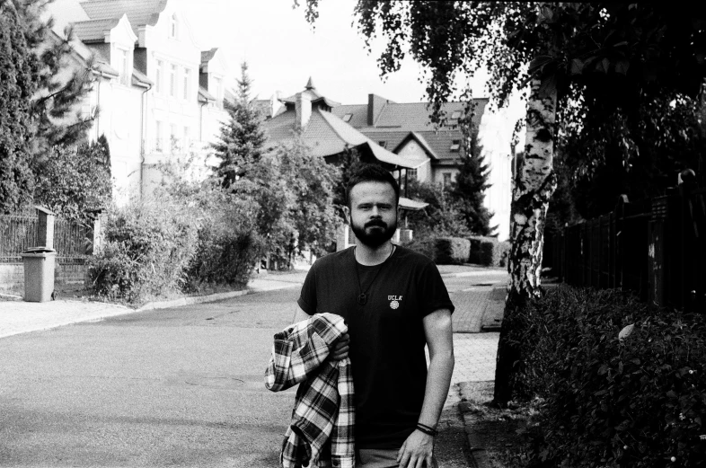 a man standing on the side of the street with a backpack