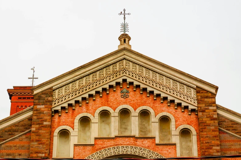 the side of a building with a steeple and decorative brick work