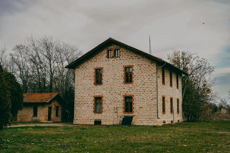 the brick building is made of stone with several windows