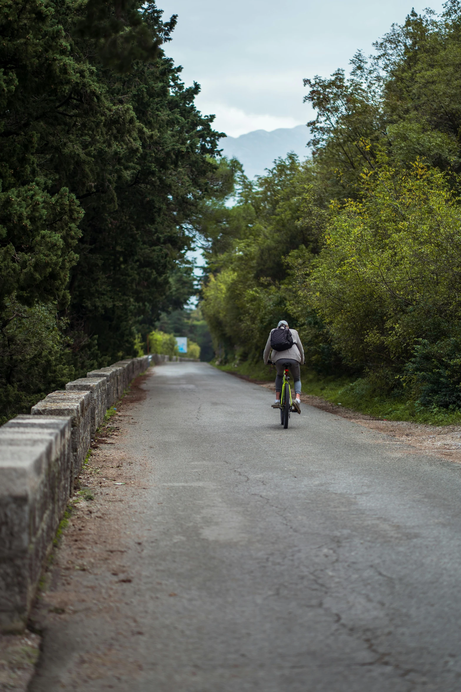 person riding their bike on a paved road