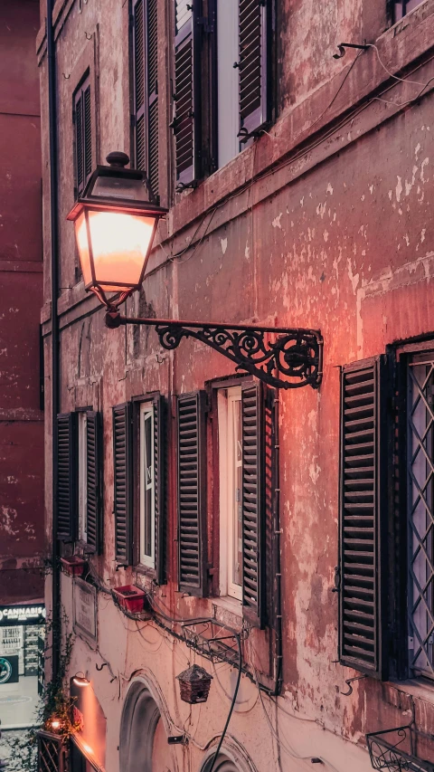 an empty street with lots of windows and a lamp