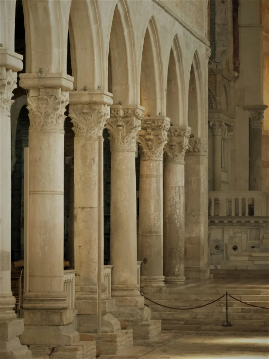 a building with many pillars and white marble floors