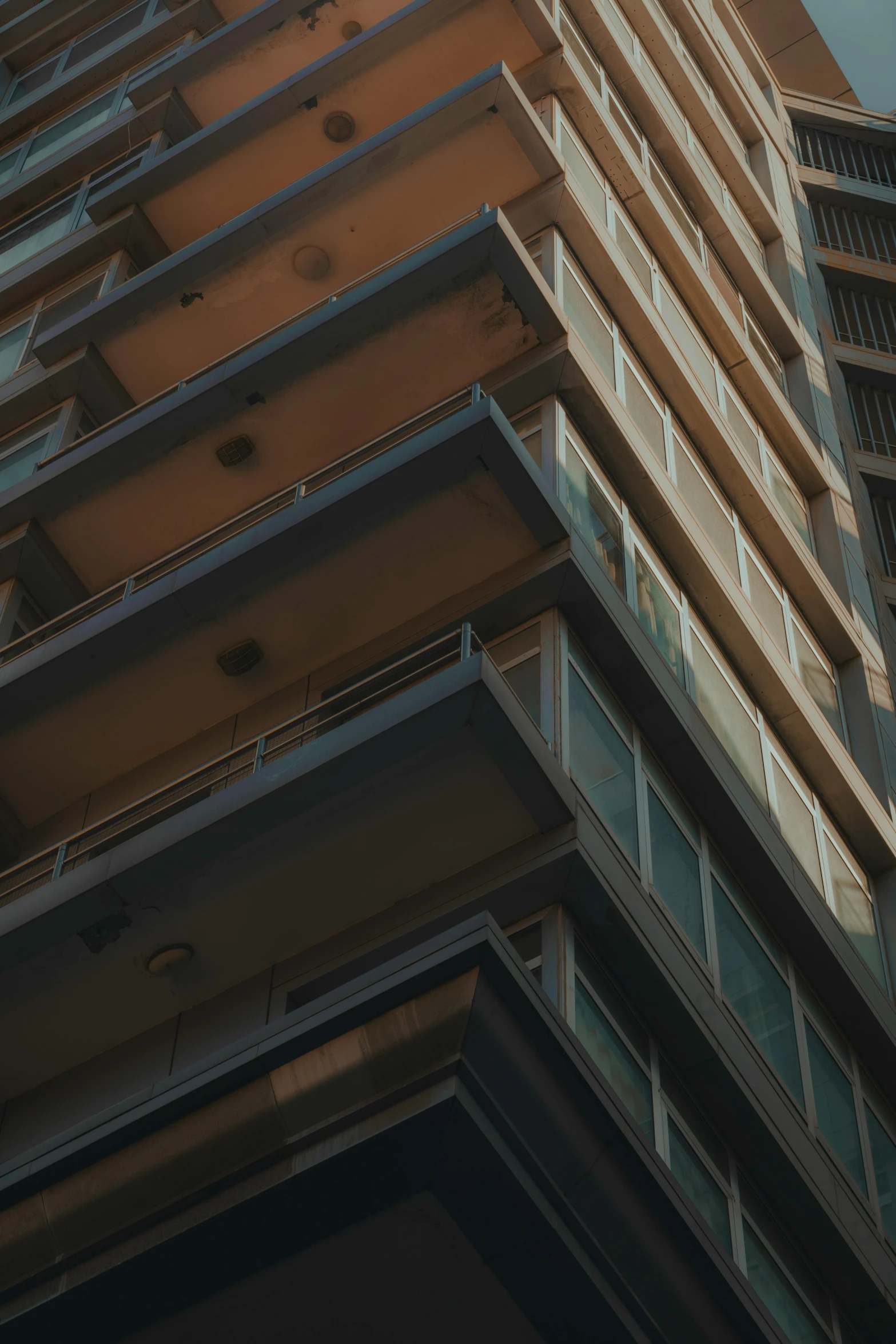 a tall brown building with a sky in the background