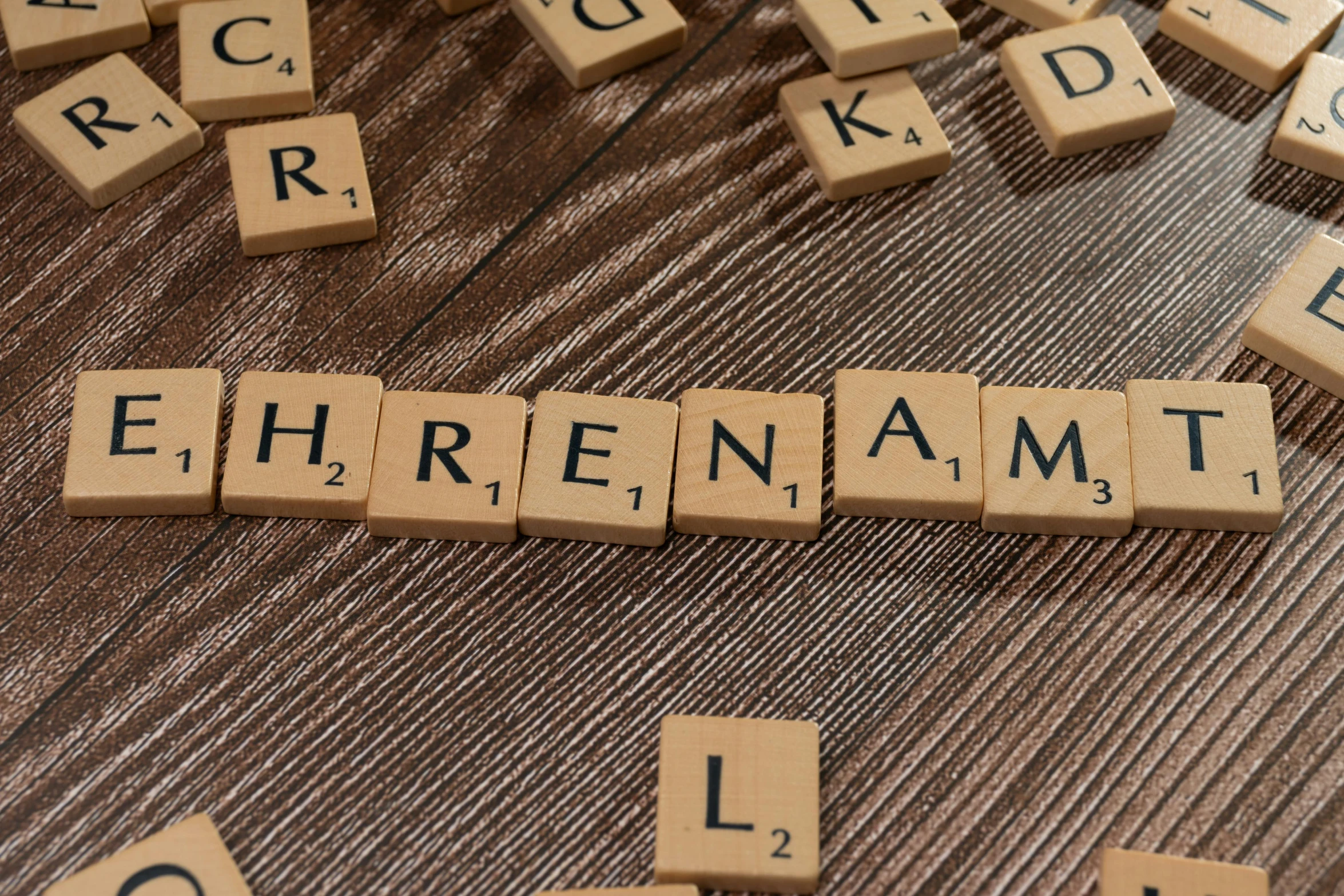 wooden tiles spelling eiffernamt on a brown table