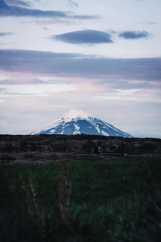 a scenic view of a snowy mountain on the horizon