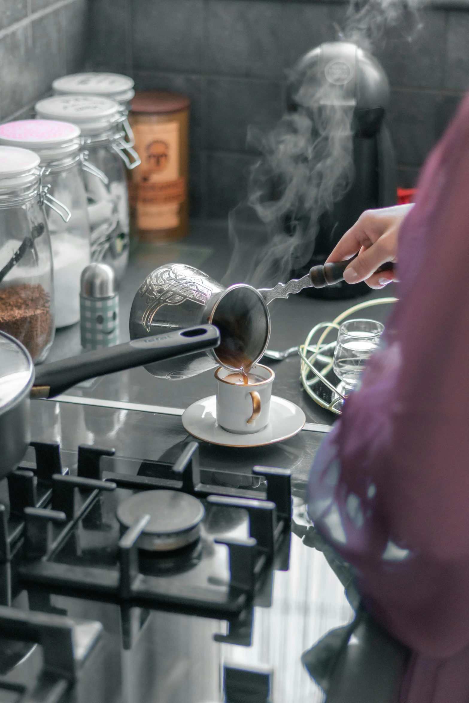 the woman is stirring the food on the stove