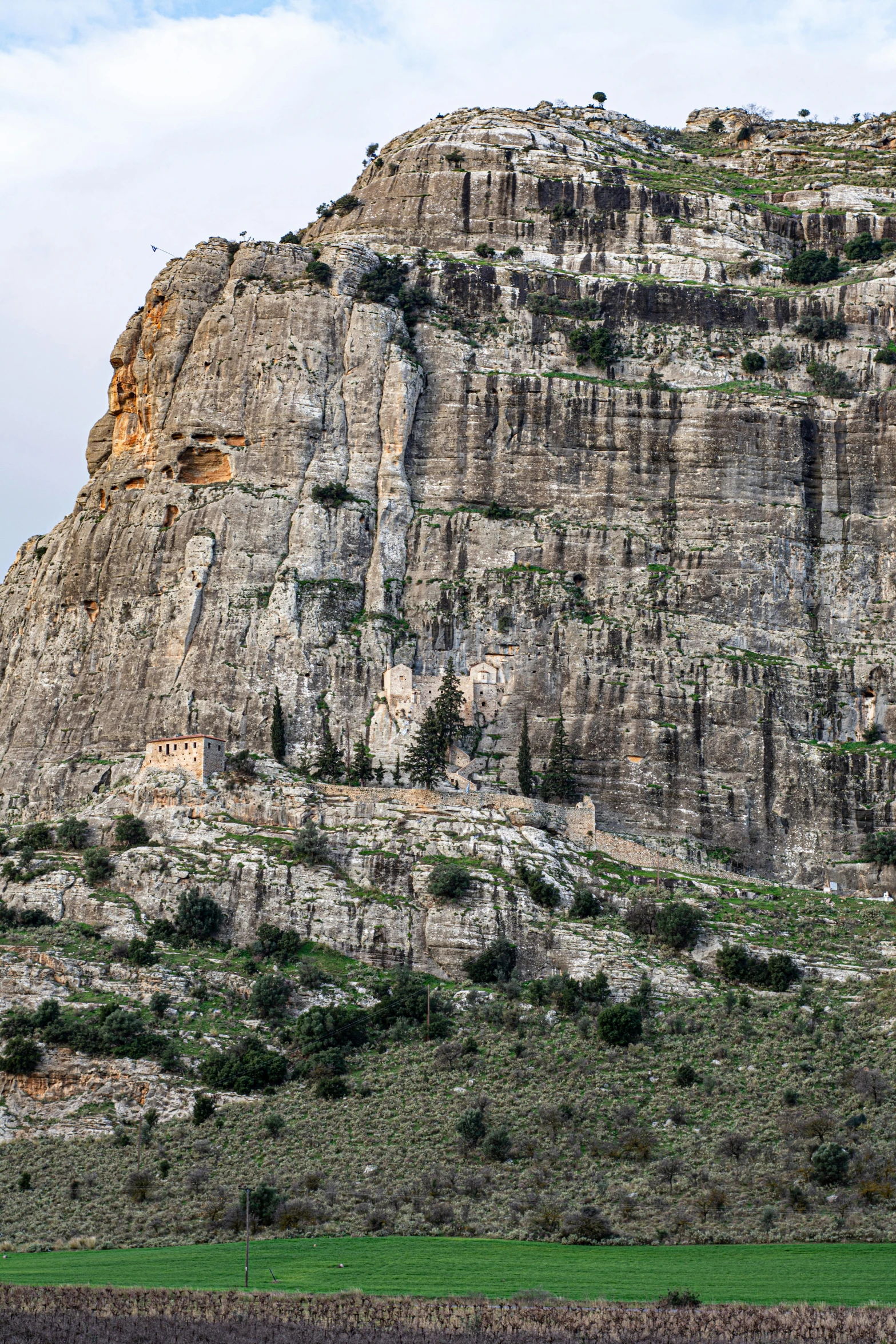 a very tall hill in front of a mountain