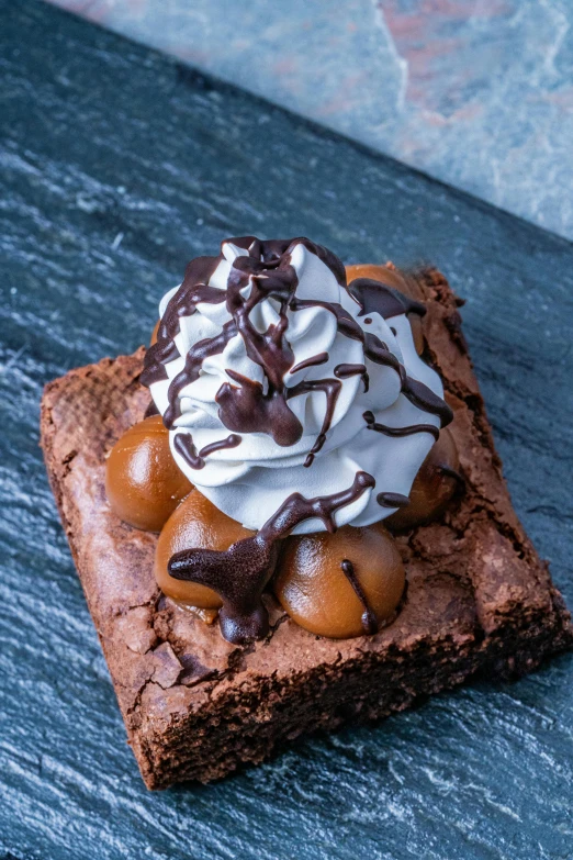 a chocolate cookie with a whipped cream on top