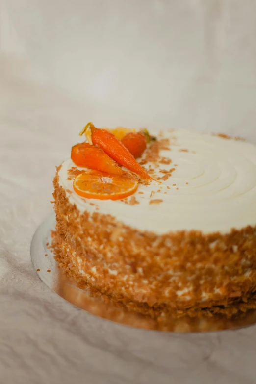 a carrot cake with frosting and chopped carrots