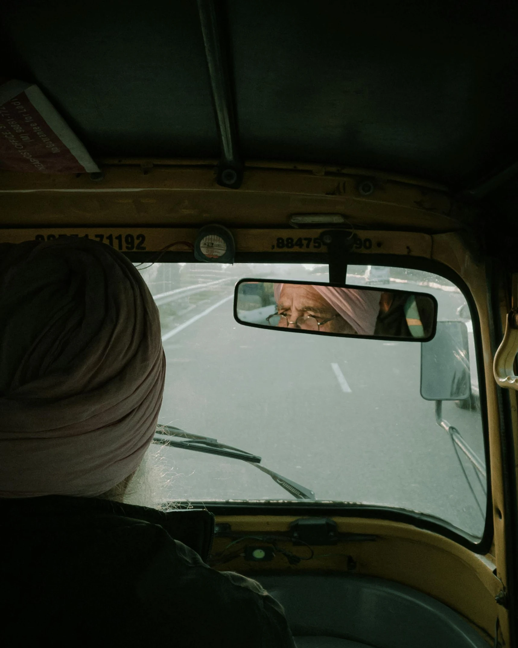 a man sitting in the drivers seat of a car