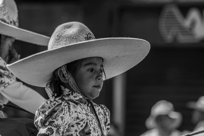 black and white po of a girl wearing a big cowboy hat