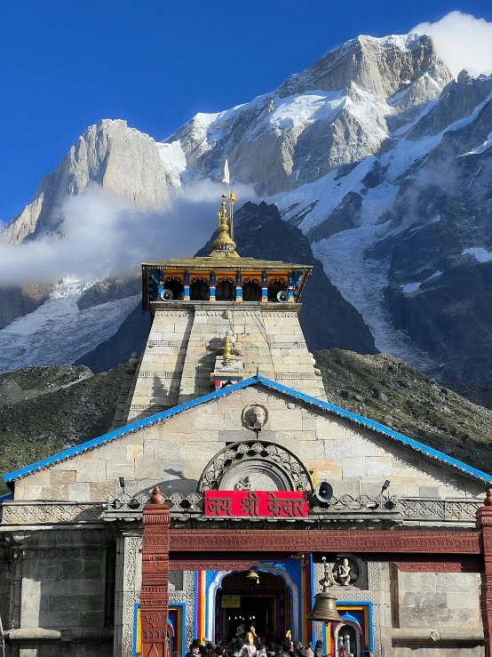 a building on the side of a mountain near a fence