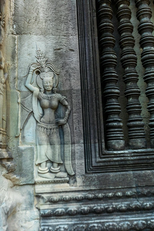 a statue on the side of a stone building