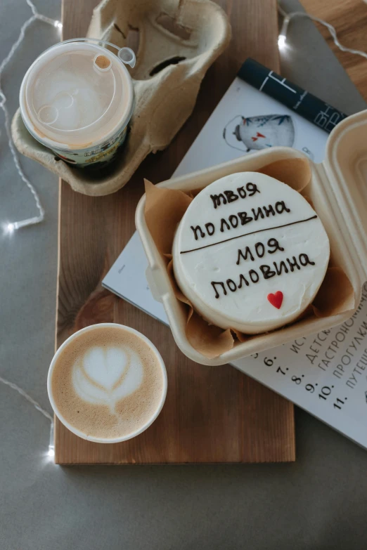 a table has cup, spoons and personalised cookies on it