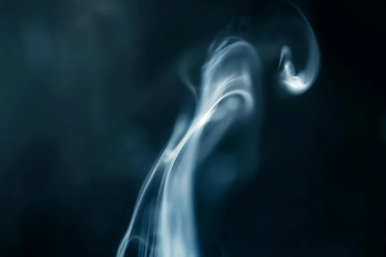 blue smoke is coming from the top of a black object