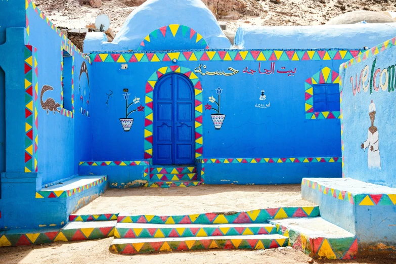 a building with steps and walls painted bright blue