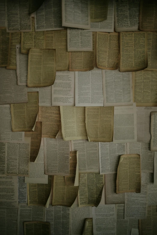 a wall of old book pages made into a tapestry