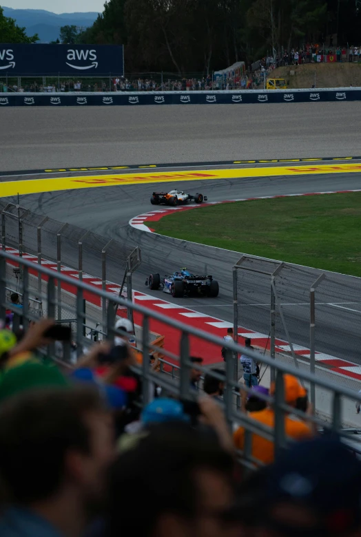 a group of racing cars turning a race track