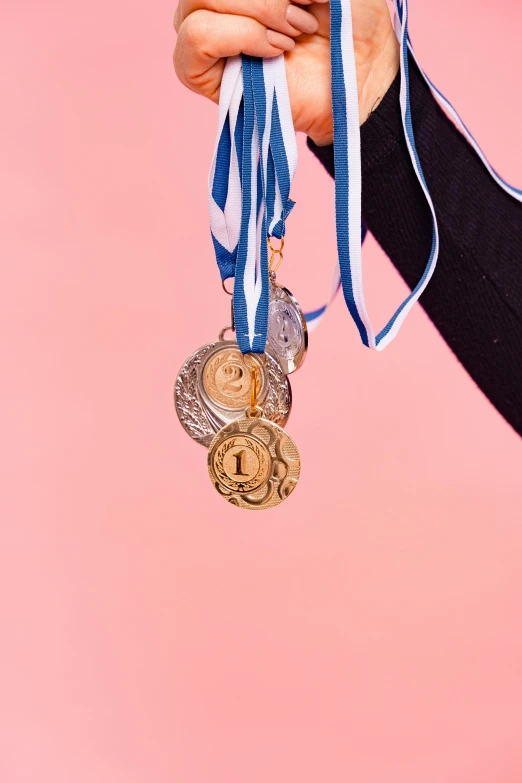 a person holding medals in their hand