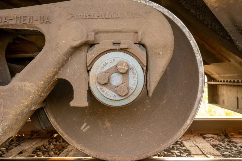 the gear is attached to an old rusty railroad track