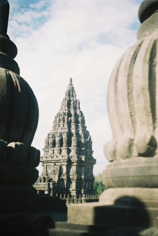 a view of an ancient stone temple next to another building