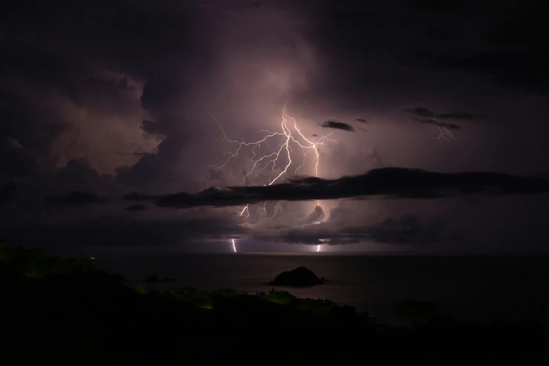 a bright storm is coming from behind some dark clouds