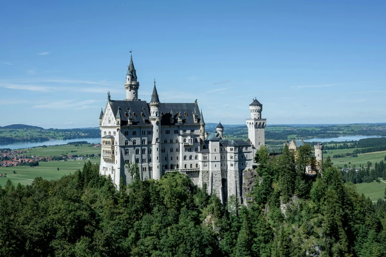 a castle stands tall in the middle of some trees