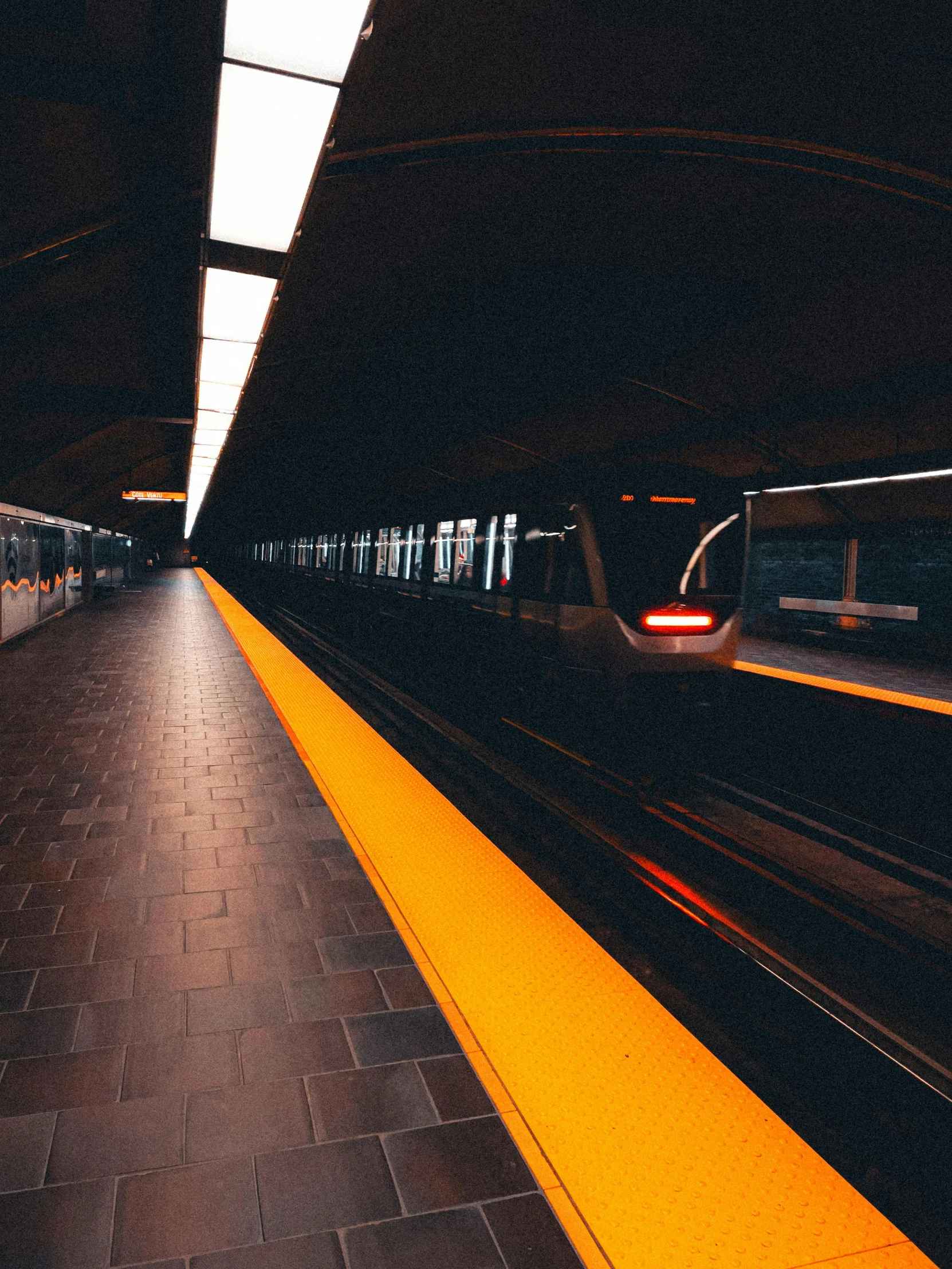 train pulling into a station at night with no lights