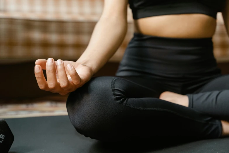 a woman practices yoga in a black top