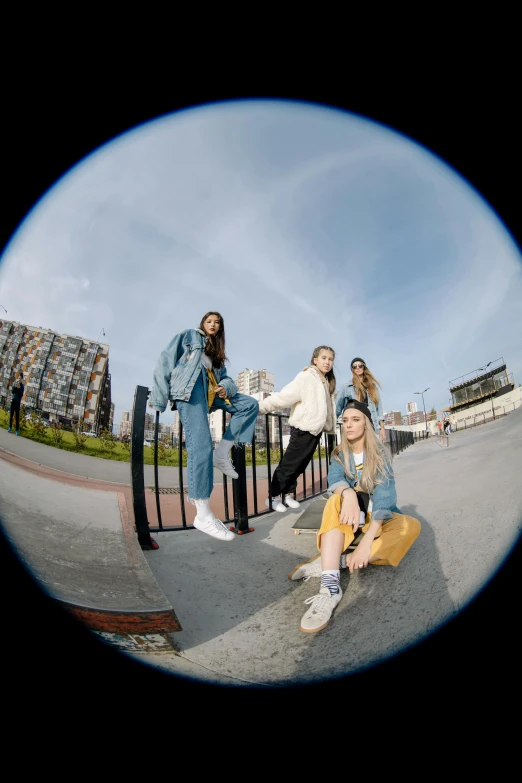 four women sitting and standing around in a circle