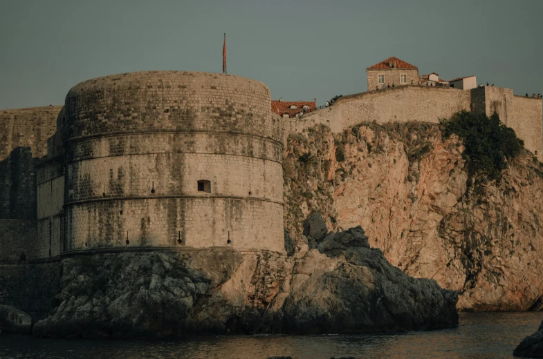 a huge stone castle is sitting on the water's edge