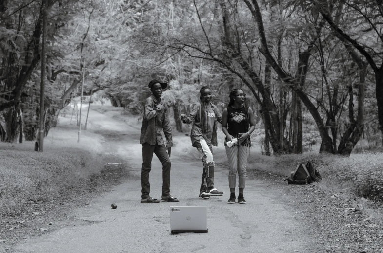 two men standing on skateboards in the woods