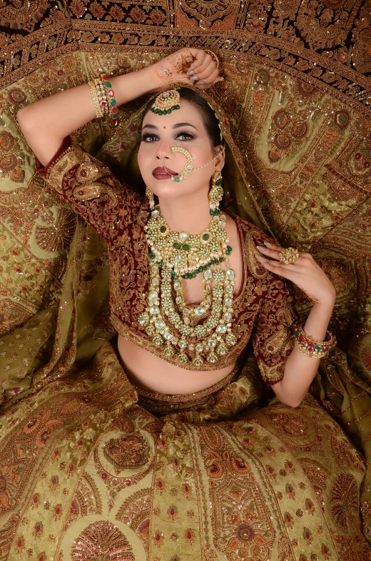 an indian woman in traditional jewelry laying on the floor