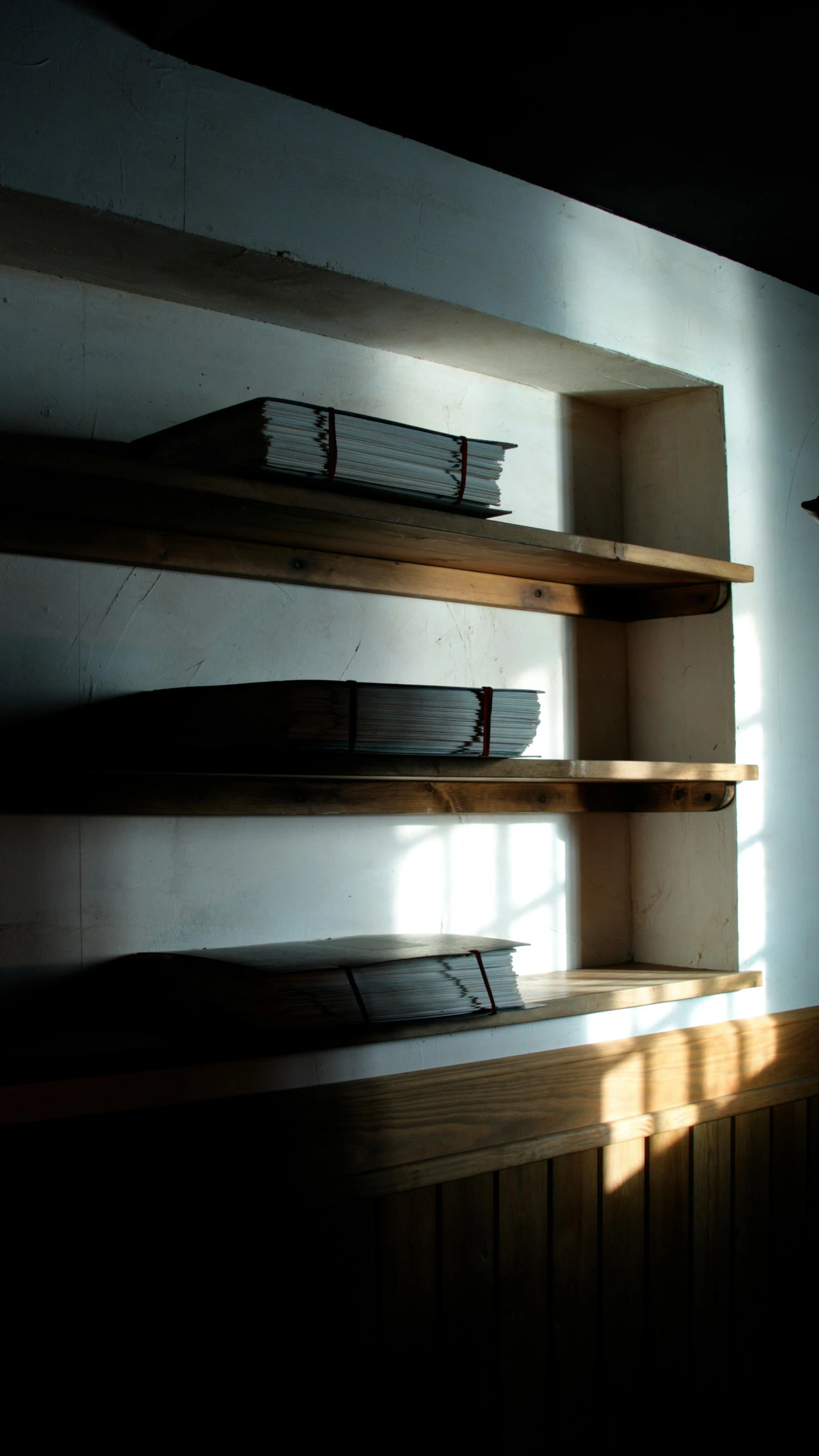 some wooden shelves in the corner of a room