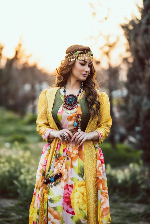 woman wearing traditional indian garb and jewelry standing in a field