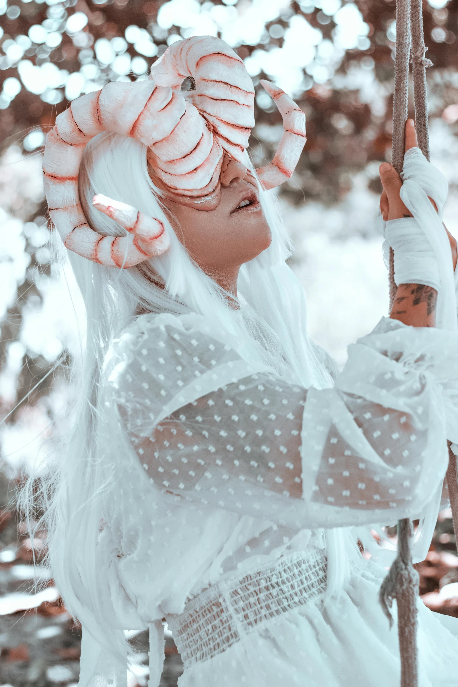 a woman with white hair is holding a stick