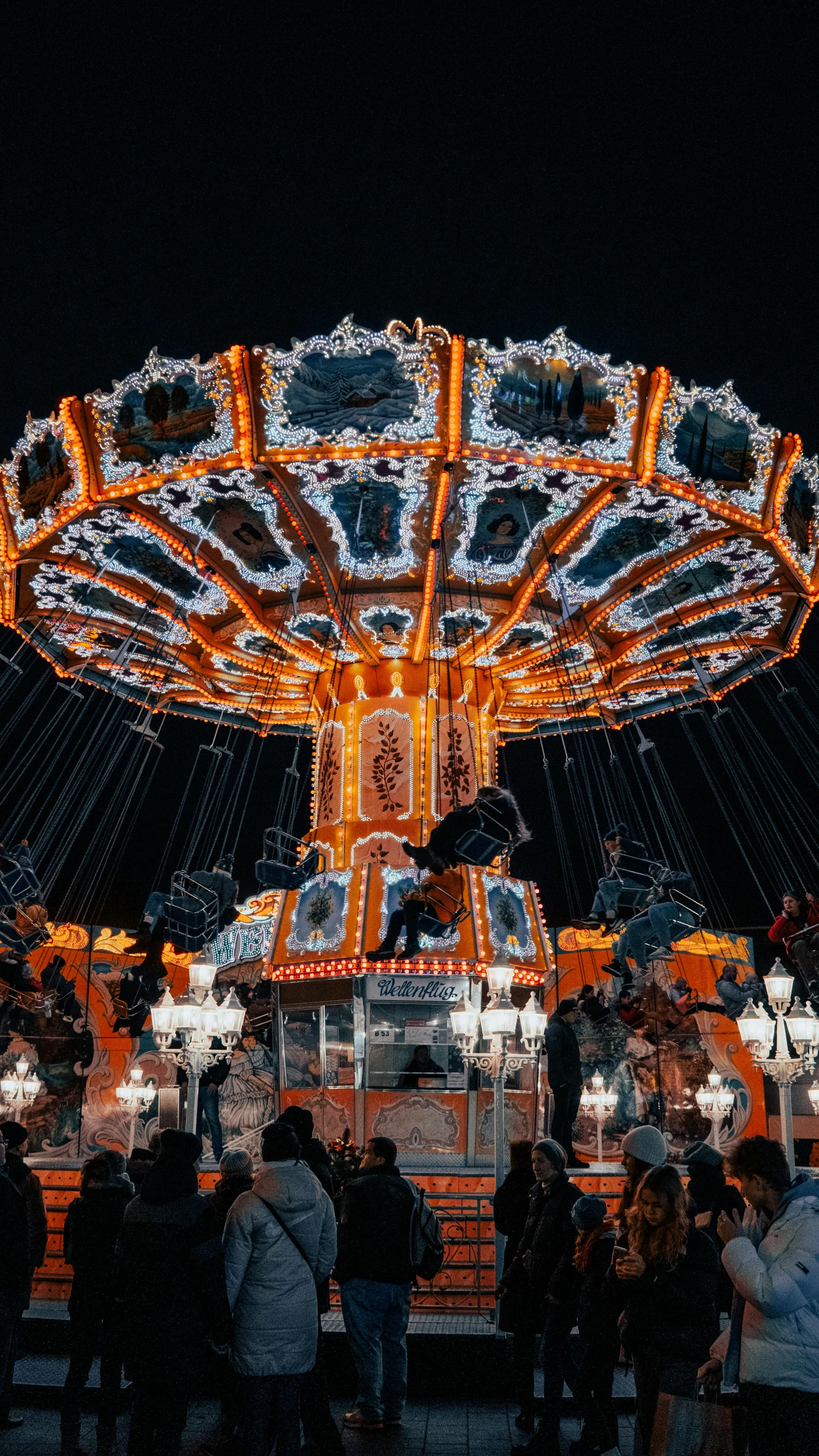 people standing around in front of a merry go round