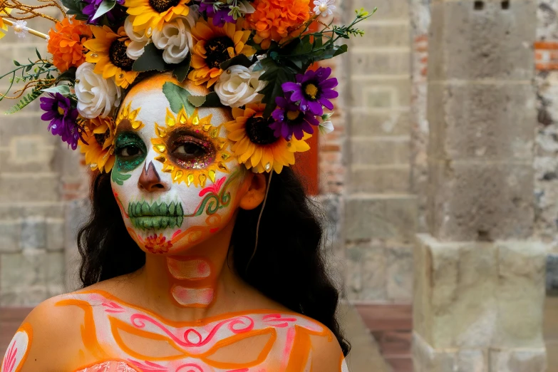 a woman with makeup painted and flowers in her hair