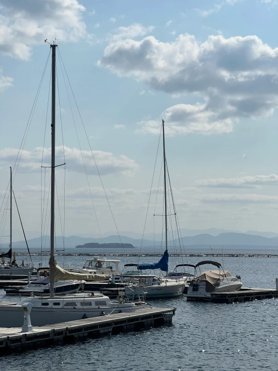 sailboats anchored in a harbor surrounded by mountains