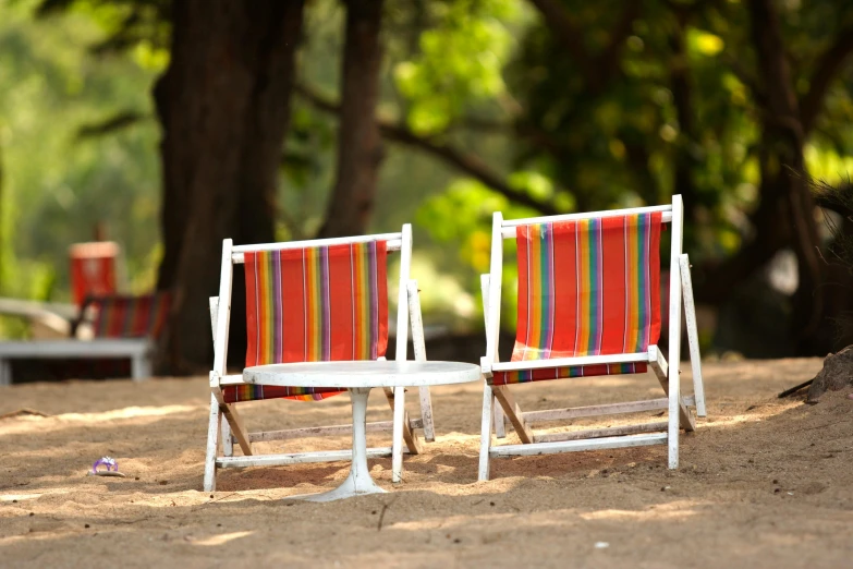 a couple of white wooden chairs next to each other