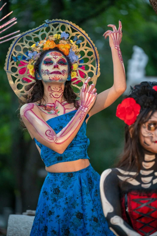 two women with their body painted in mexican style