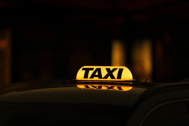 a taxi sign is shown at night time