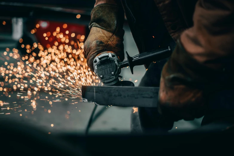 a man is  metal with a power saw