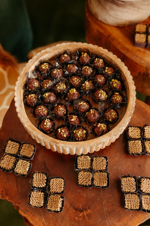 a large wooden tray with chocolates in it