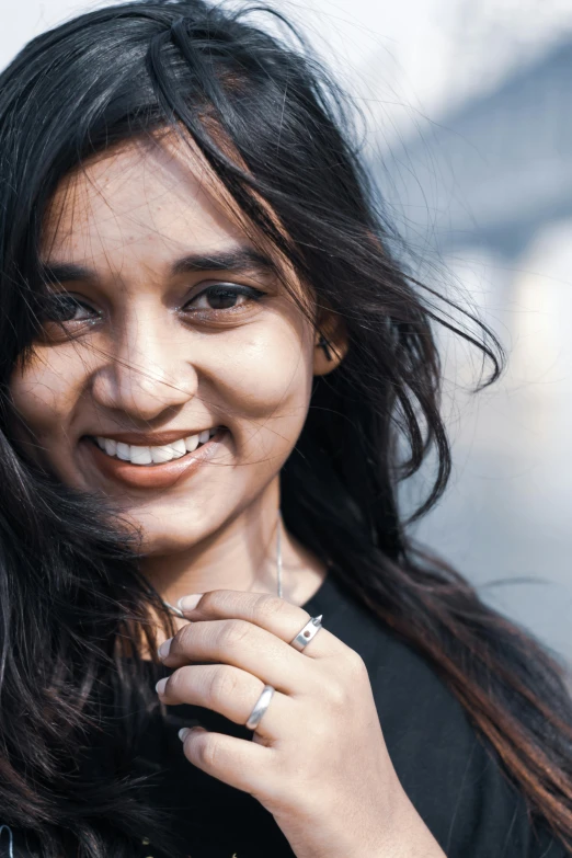 a girl smiling with her hands in her pocket