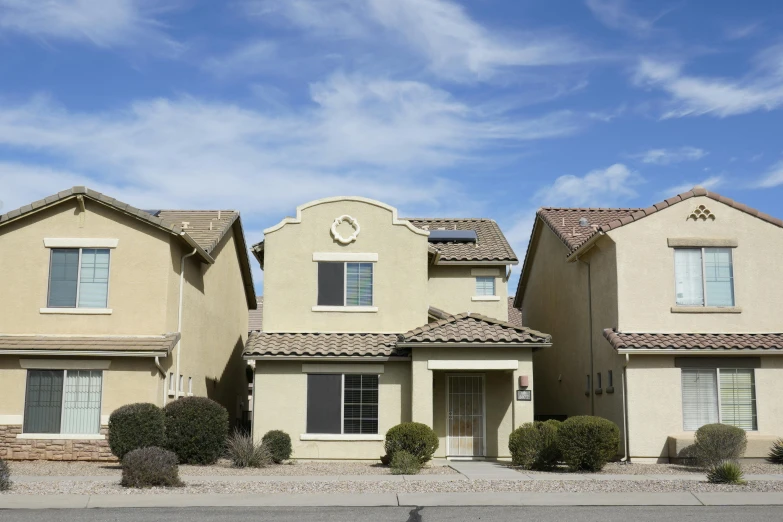 three story houses with a blue sky in the background