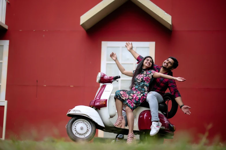 there is a woman and a man riding a scooter