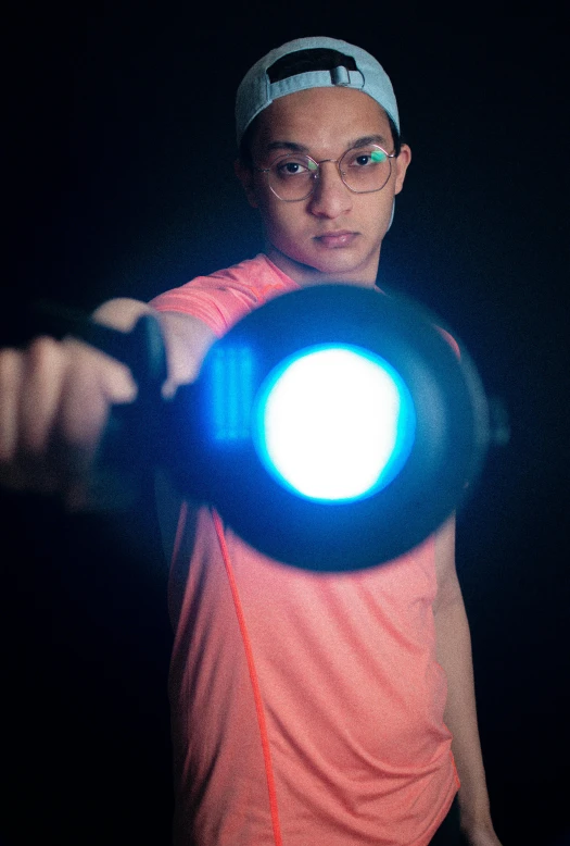 a man holding a glowing disc with both hands