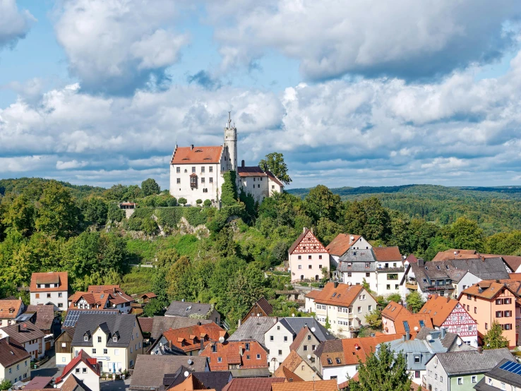 a city is shown in the foreground with a tall tower in the background