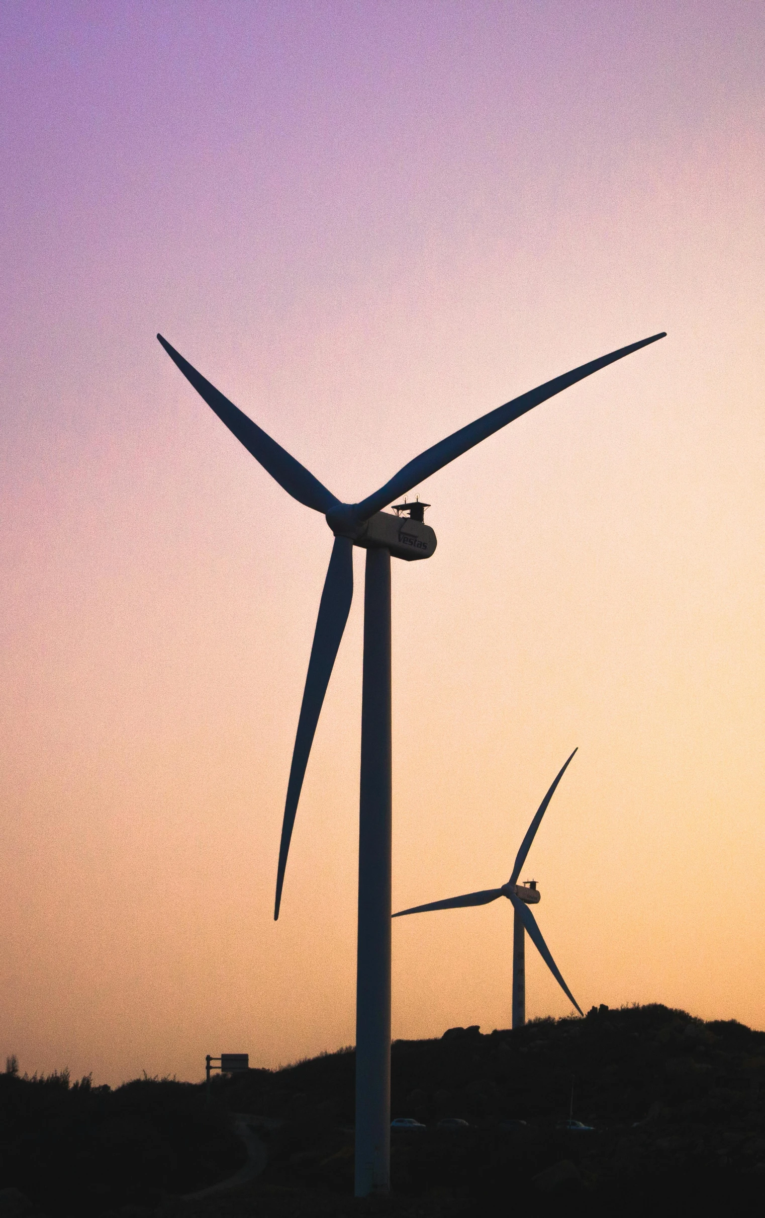 a picture of some windmills in the sunset